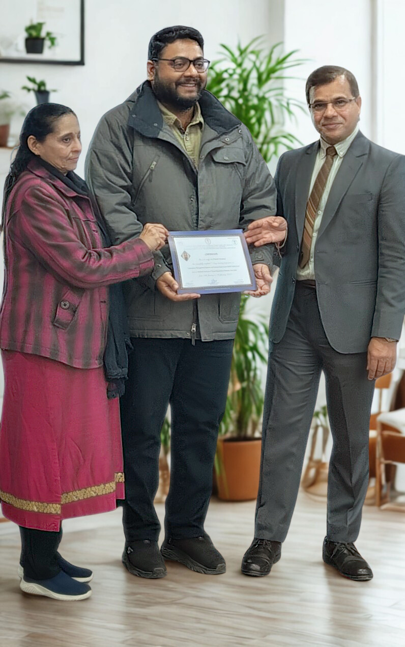 Dr. Prateek receiving a certificate with his parents
